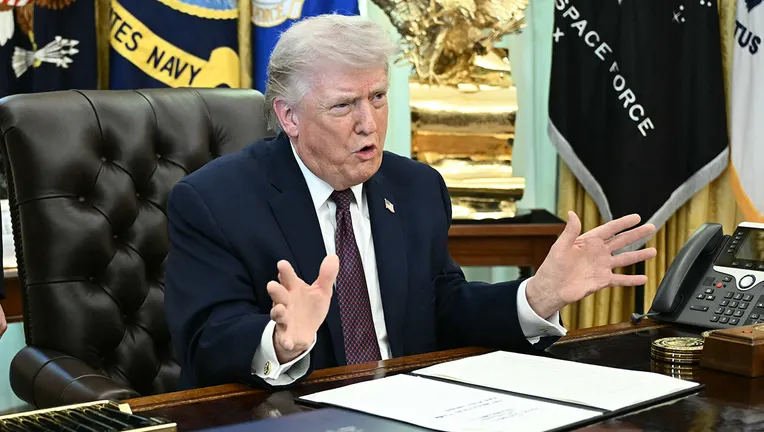 President Trump sits at desk